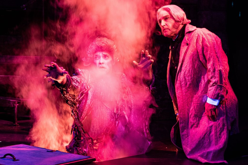 Scrooge (Jeff Sanzel) and Jacob Marley (Stephen T. Wangner) in A Christmas Carol at Theatre Three 2024