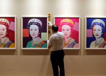 Royal Collection Trust Exhibition Conservator David Westwood hangs portraits of Queen Elizabeth II by Andy Warhol as part of the exhibition The Queen: Portraits of a Monach being shown at Windsor Castle.