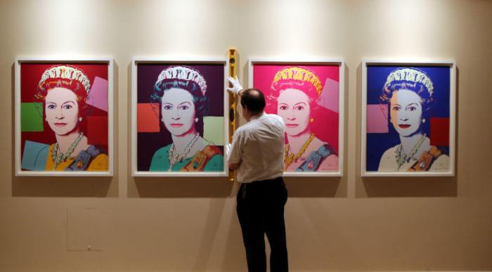 Royal Collection Trust Exhibition Conservator David Westwood hangs portraits of Queen Elizabeth II by Andy Warhol as part of the exhibition The Queen: Portraits of a Monach being shown at Windsor Castle.