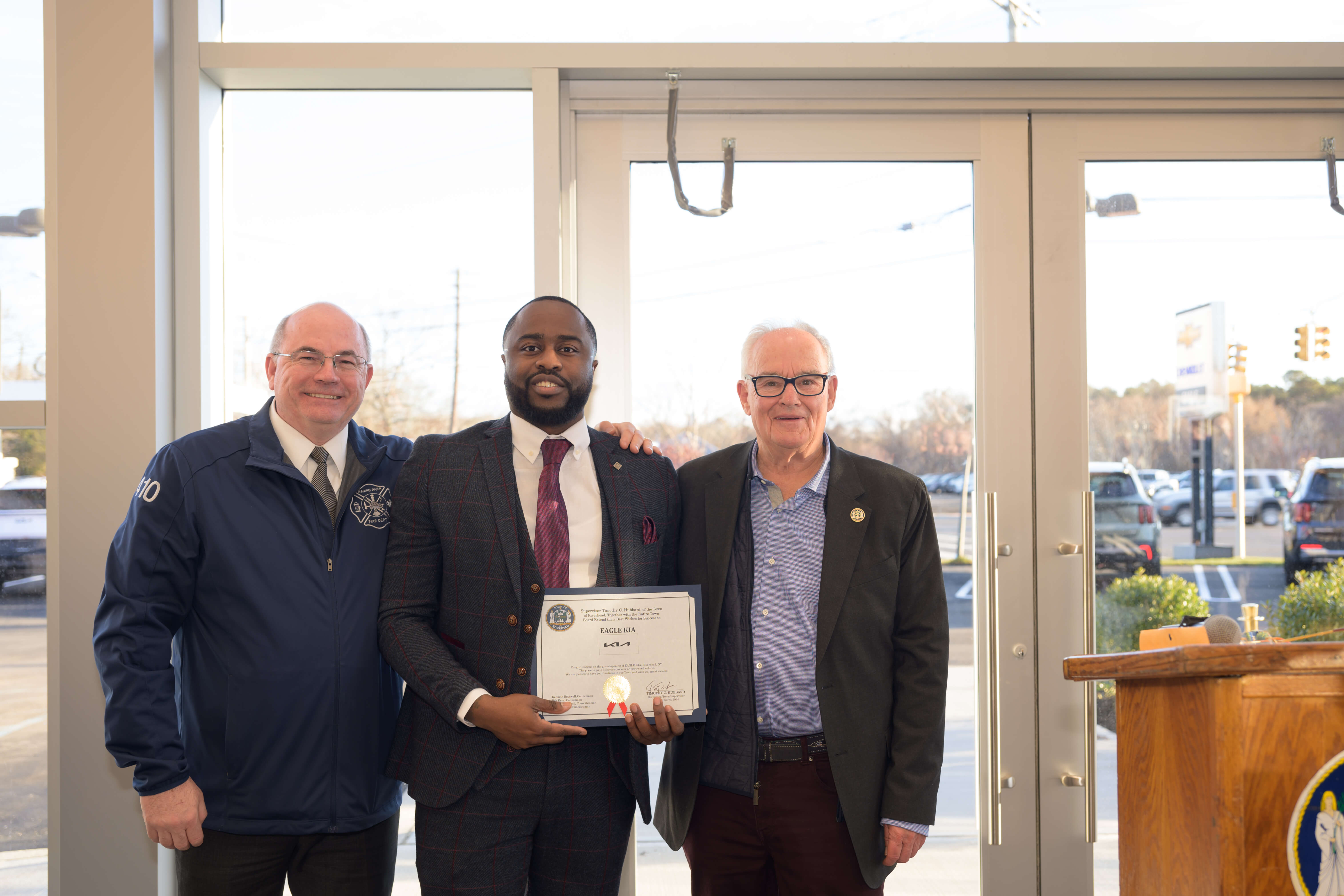 From left, Riverhead Councilman Ken Rothwell, Adonai McCormack, and Councilman Bob Kern. McCormack was given a certificate from the Town of Riverhead at Eagle Kia