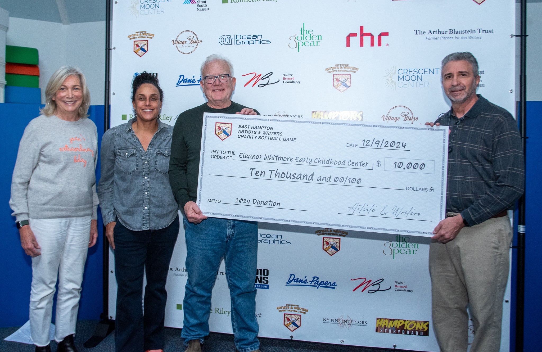 David Brandman (Pres A&W Game) presents check to Joan Overlock, Mercedes Counihan, Tim Frazer of the Eleanos Whitmore Early Childhood Center from this years Artists & Writers Game 2024