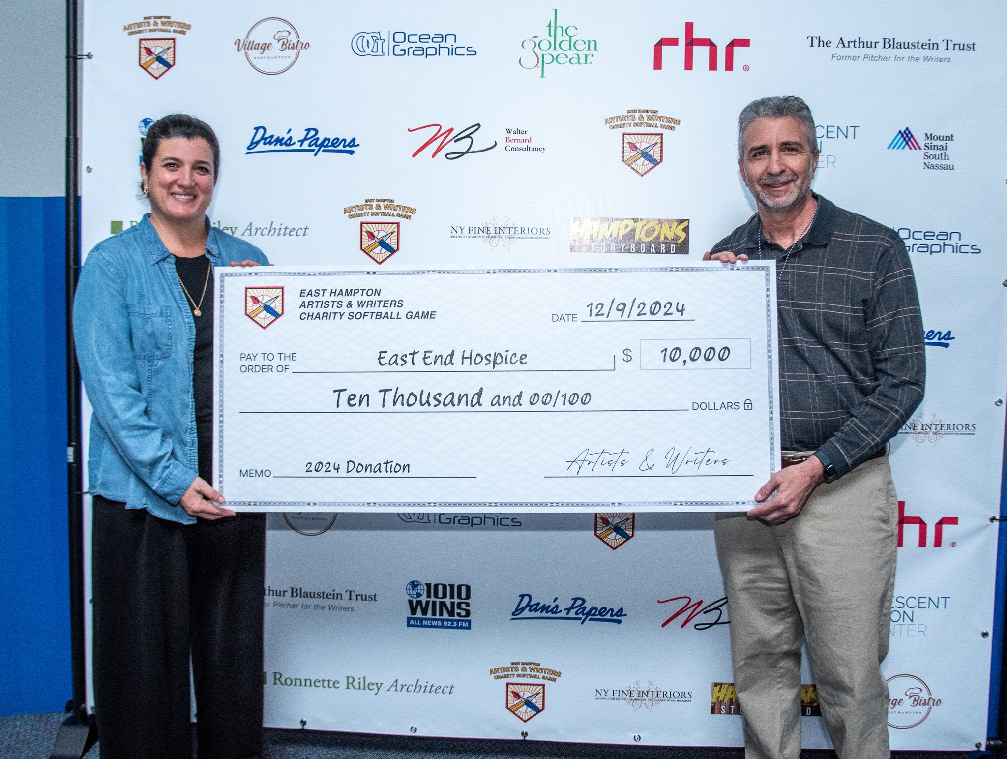 David Brandman presents check to Mary Crosby (Pres & CEO) of East End Hospice from this years Artists & Writers Game 2024