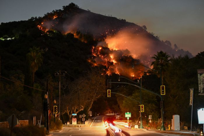 A view of flames at the mountain as seen from Topanga Canyon near Pacific Palisades in Topanga, Los Angeles, California, United States on January 9, 2025. A fast-moving wildfire has forced 180,000 people to evacuate, with officials warning that worsening winds could further escalate the blaze.