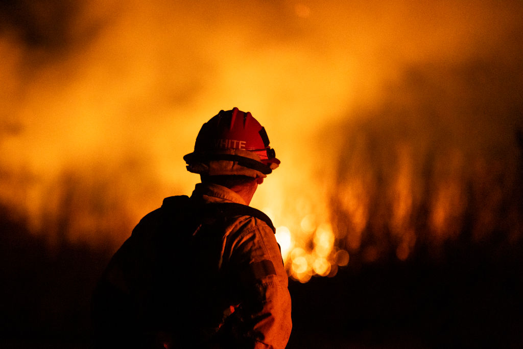 A firefighter monitors the spread of the Auto Fire in Oxnard, North West of Los Angeles, California, on January 13, 2025. US officials warned that "dangerous and strong" winds were set to push deadly wildfires further through Los Angeles residential areas January 12 as firefighters struggled to make progress against the flames. At least 24 people have been confirmed dead from blazes that have ripped through the city, reducing whole neighborhoods to ashes and leaving thousands without homes.Photo by ETIENNE LAURENT/AFP via Getty Images.