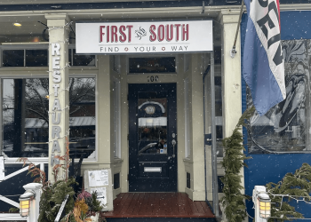 Snow falls in front of First and South in Greenport – while it stays open.