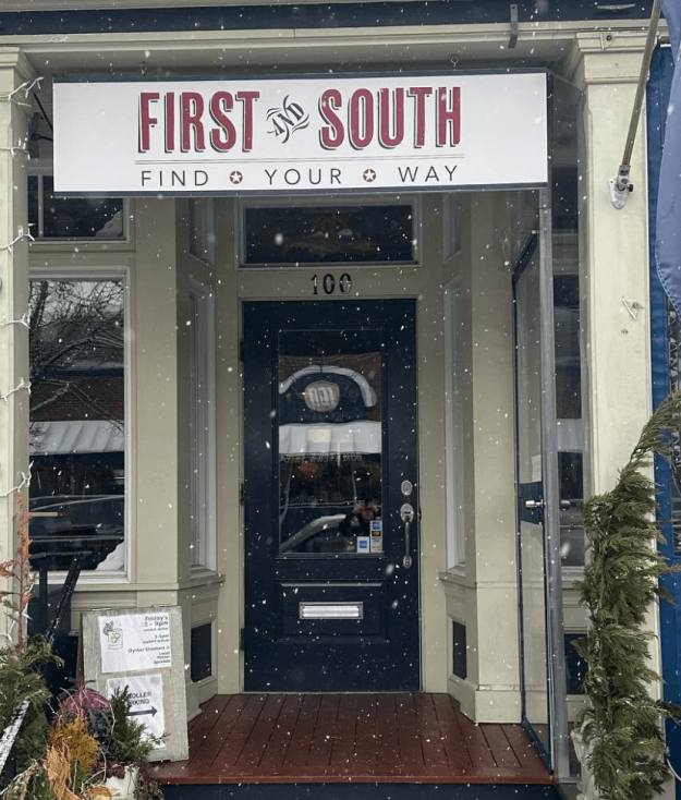 Snow falls in front of First and South in Greenport – while it stays open.