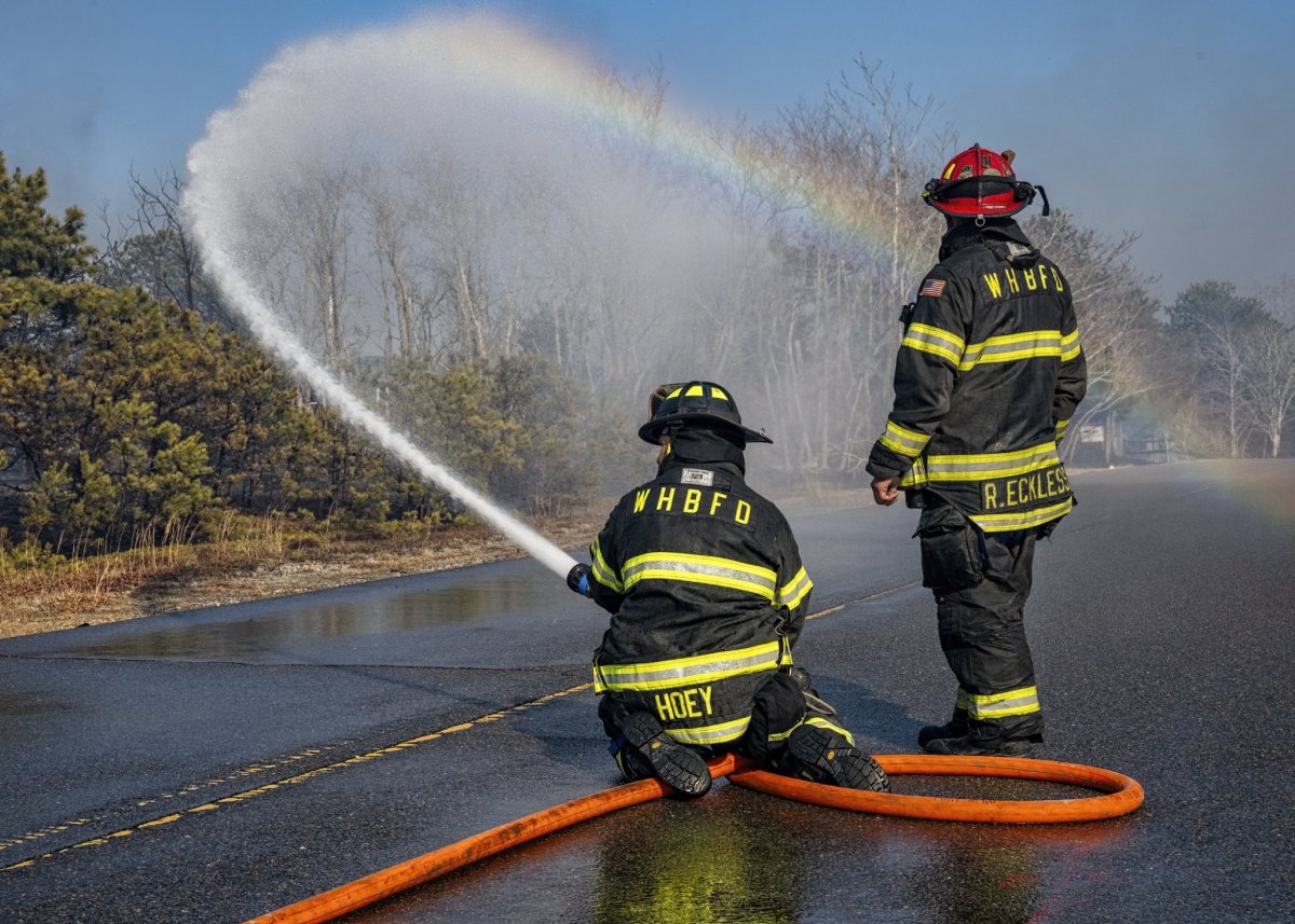 Firefighters hose down the Westhampton brush fire (John Neely)