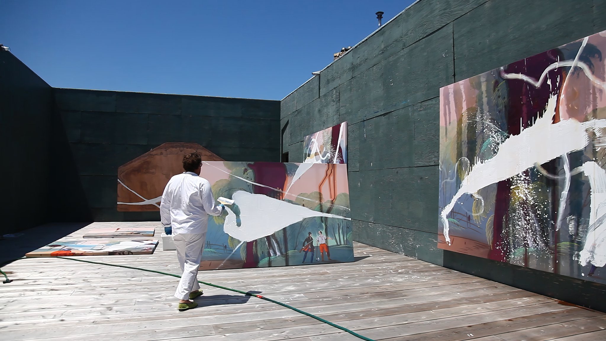 Julian Schnabel painting in his outdoor studio in Montauk